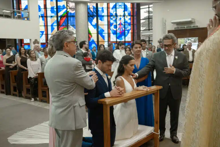 Momento de fé e emoção:Mariana e Pedro recebem a bênção ladeados pelos pais.